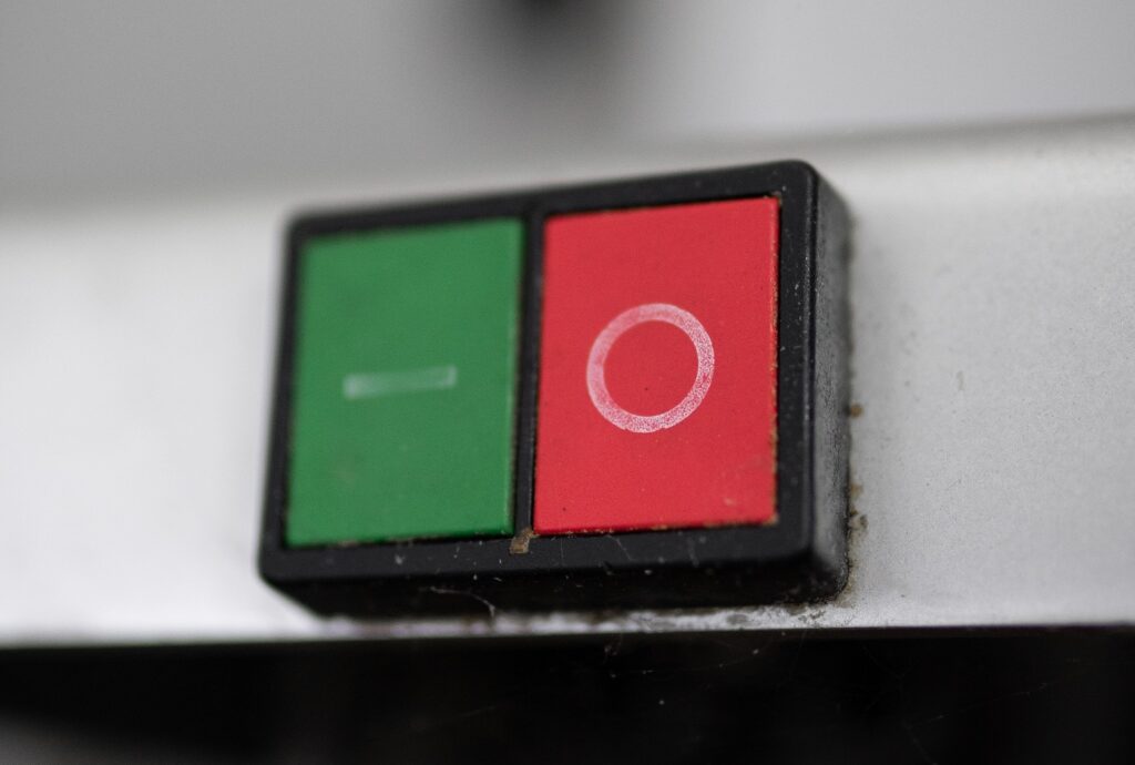 Photo of old fashioned on/off buttons, in green and red..